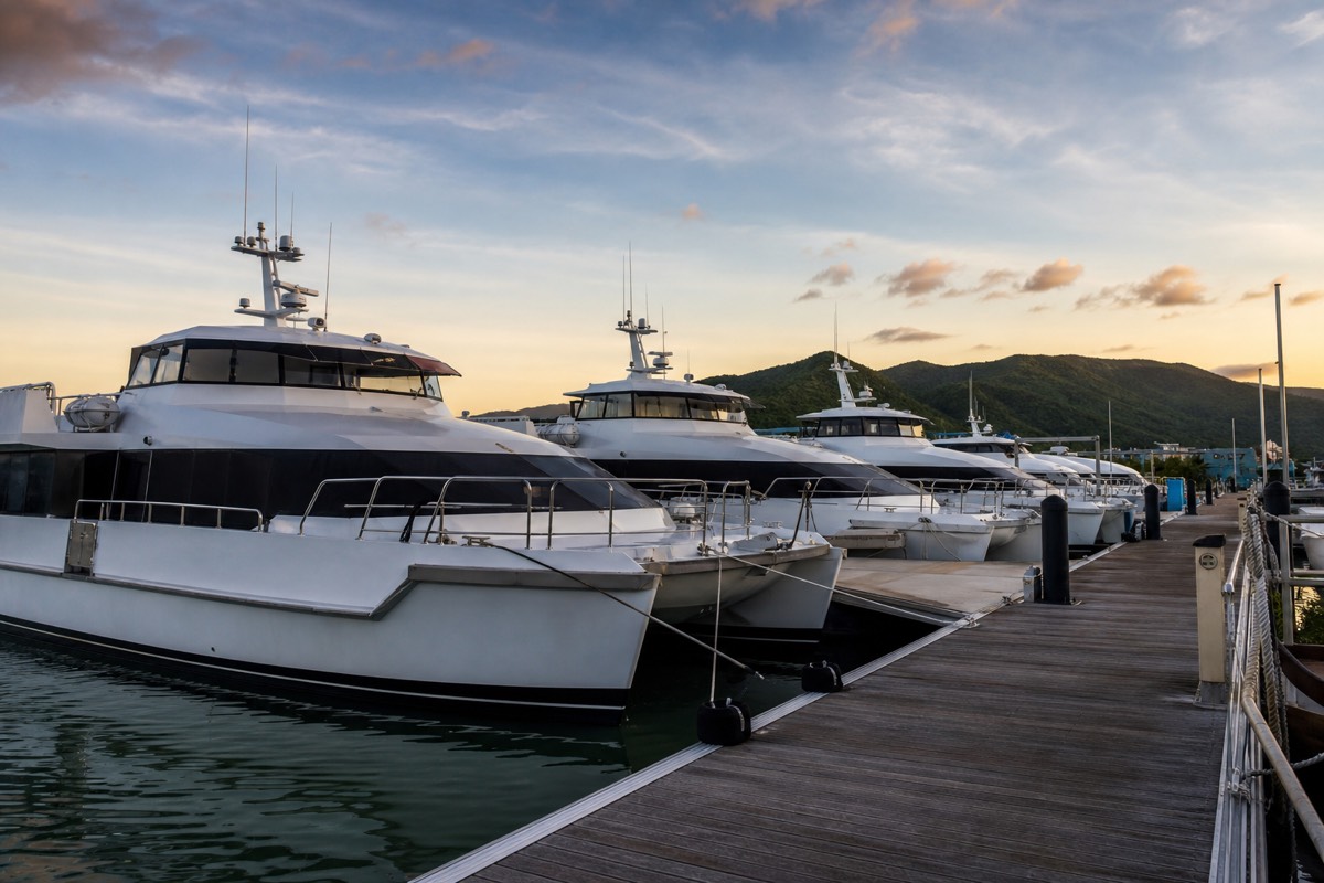A white tour catamaran moored at Cairns Marlin Marina at sunrise, ready to depart for the Great Barrier Reef
